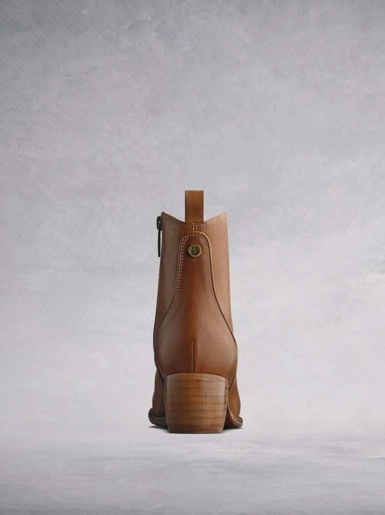Finished with a stacked Cuban heel and a decorative rear pull-tab.