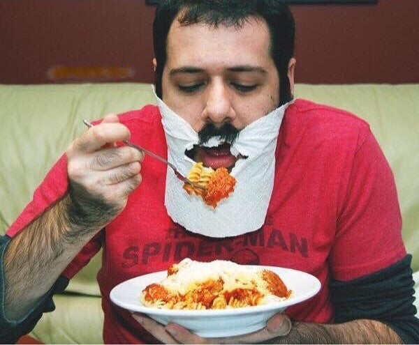Man eating with a beard