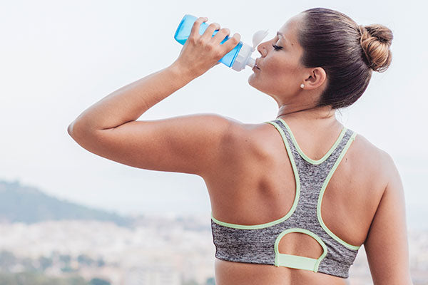 Healthy woman drinking water