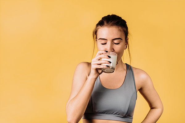 Woman taking probiotic supplement