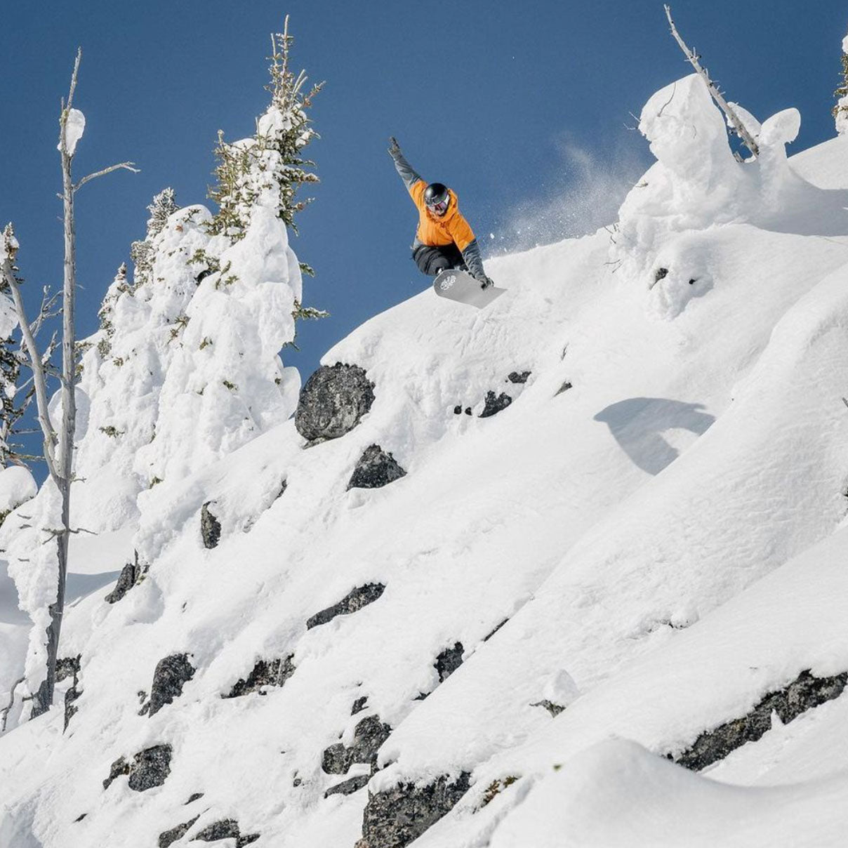 Nils does a grab going down a snow covered mountain