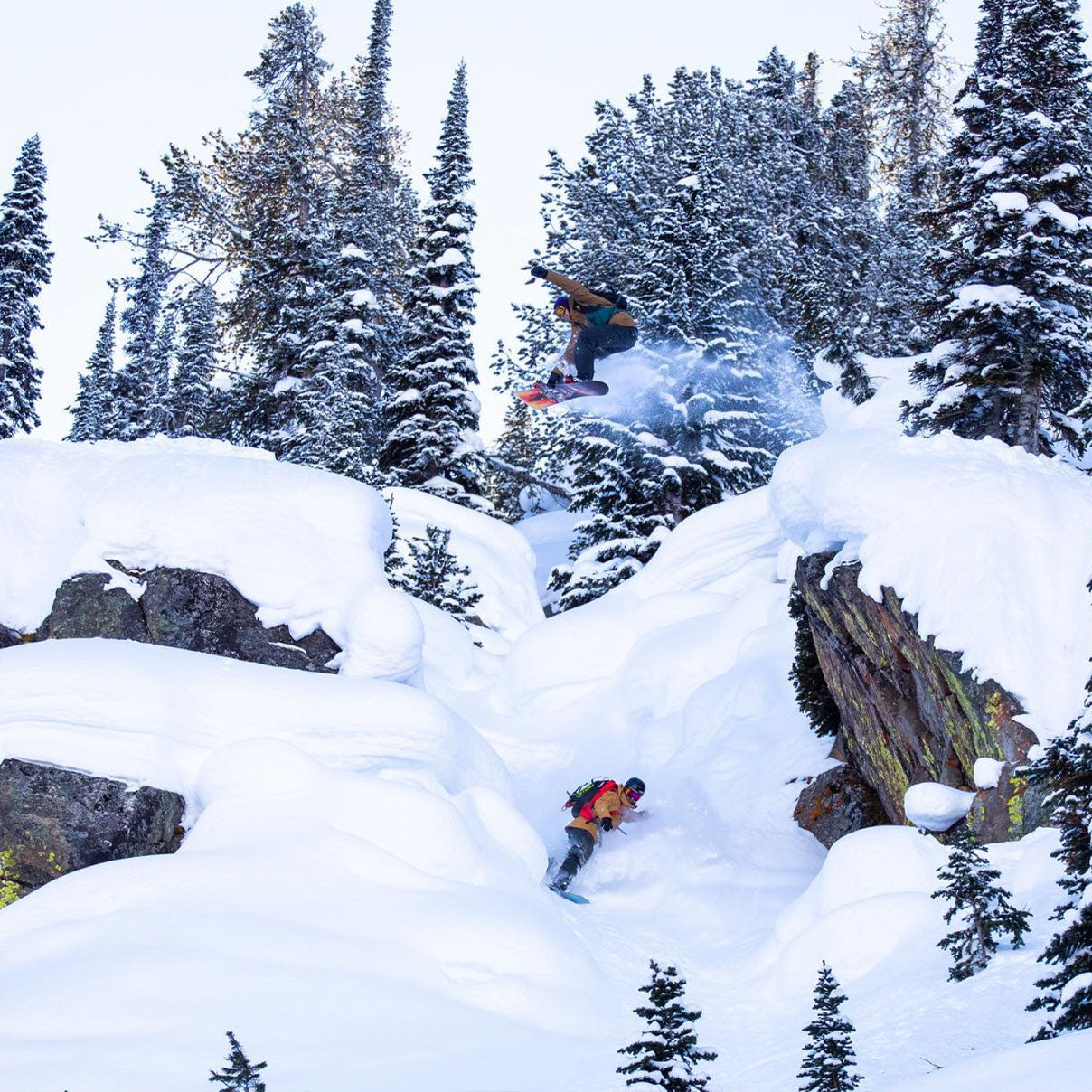 Nils and his friend cruise down a powder mountain on their snowboards