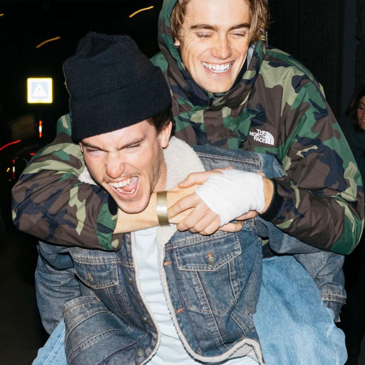 blake getting a piggy back ride from a friend during a Vans Snowboarding event