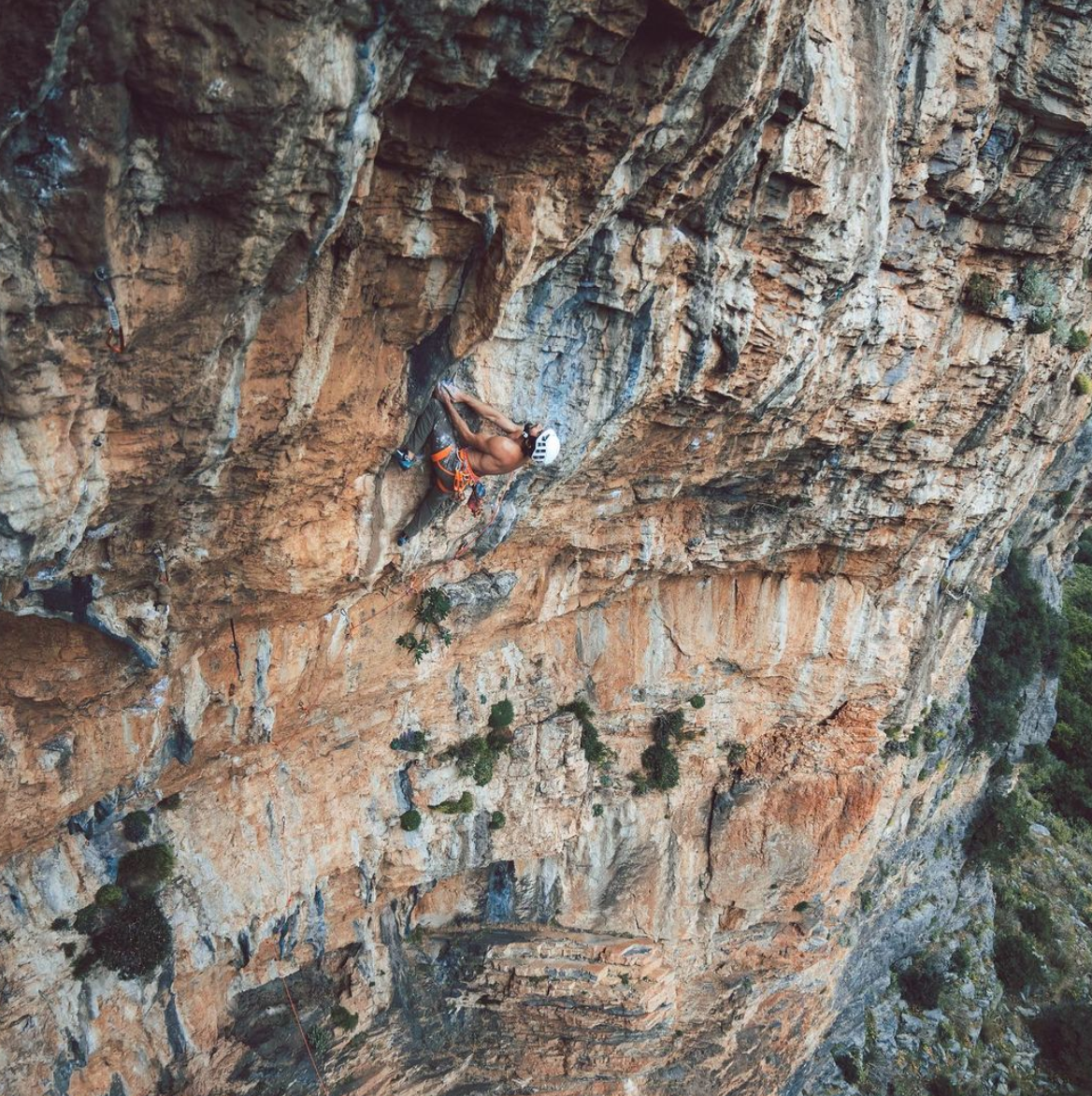 matty climbing a mountain wearing a helmet