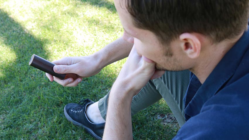 young man thinking about how good the PAX 2 is