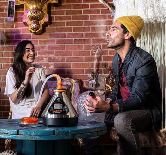 two people enjoying the Volcano Hybrid Vaporizer with whip and balloon delivery