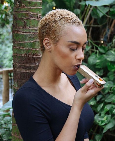 woman in forest enjoys the Firefly 2+ Vaporizer