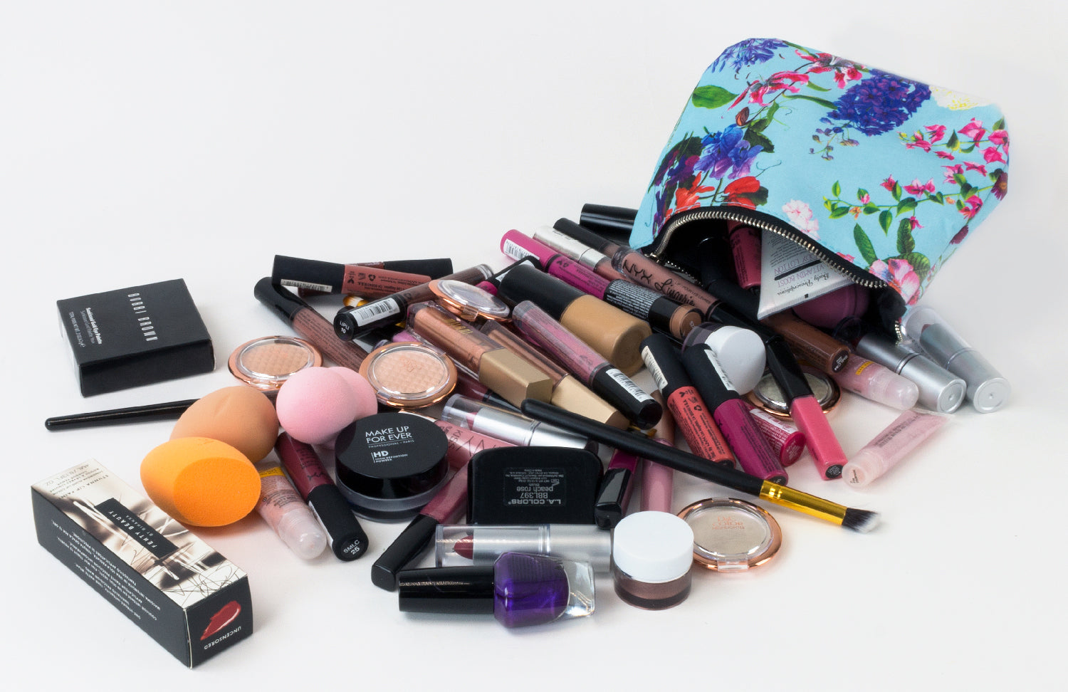 a pile of makeup coming out of a cosmetic bag