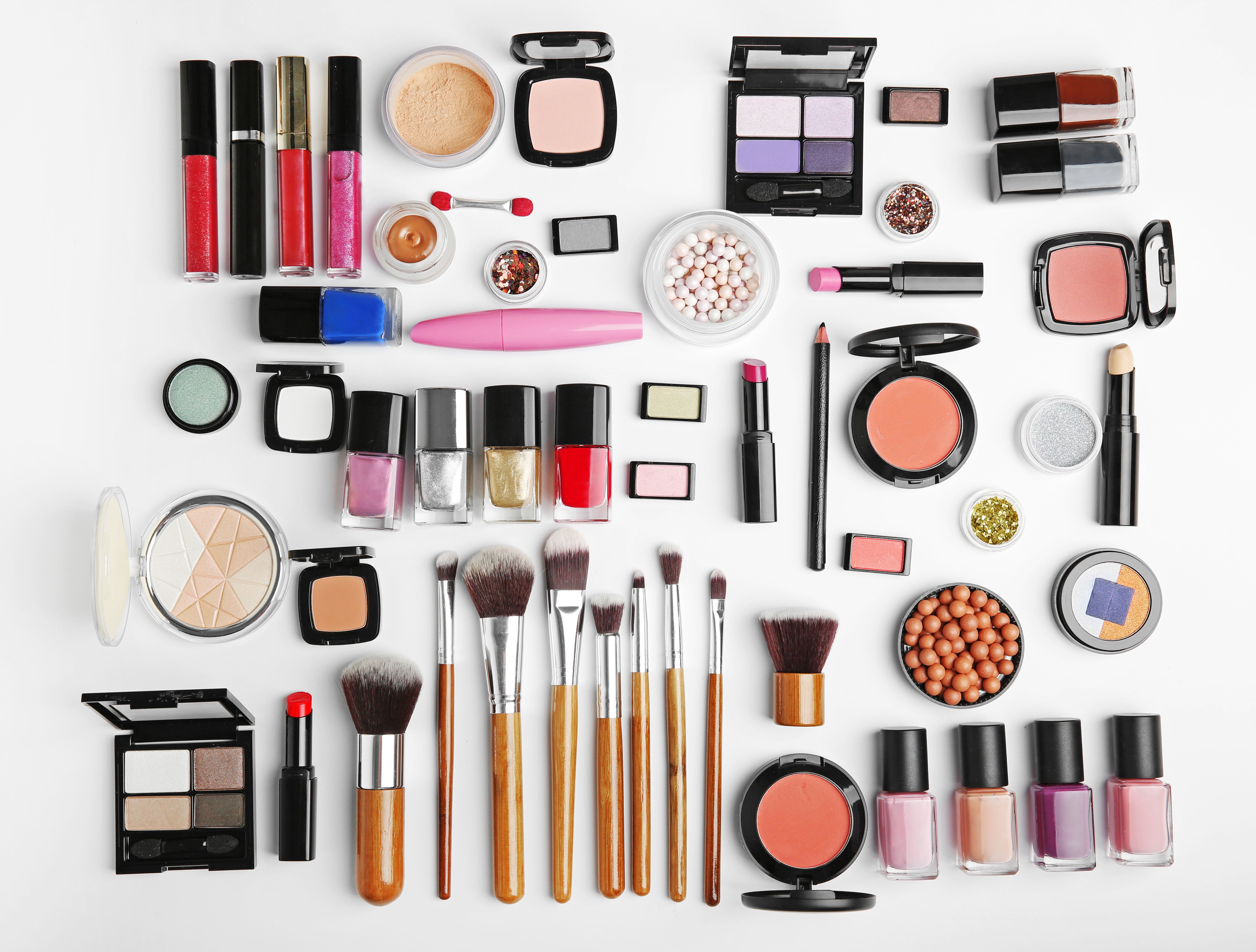 Flat-lay stock image of makeup categorized by type