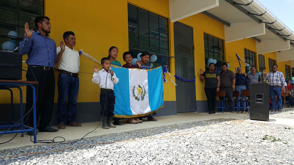 A boy leads in singing the national anthem of Guatemala