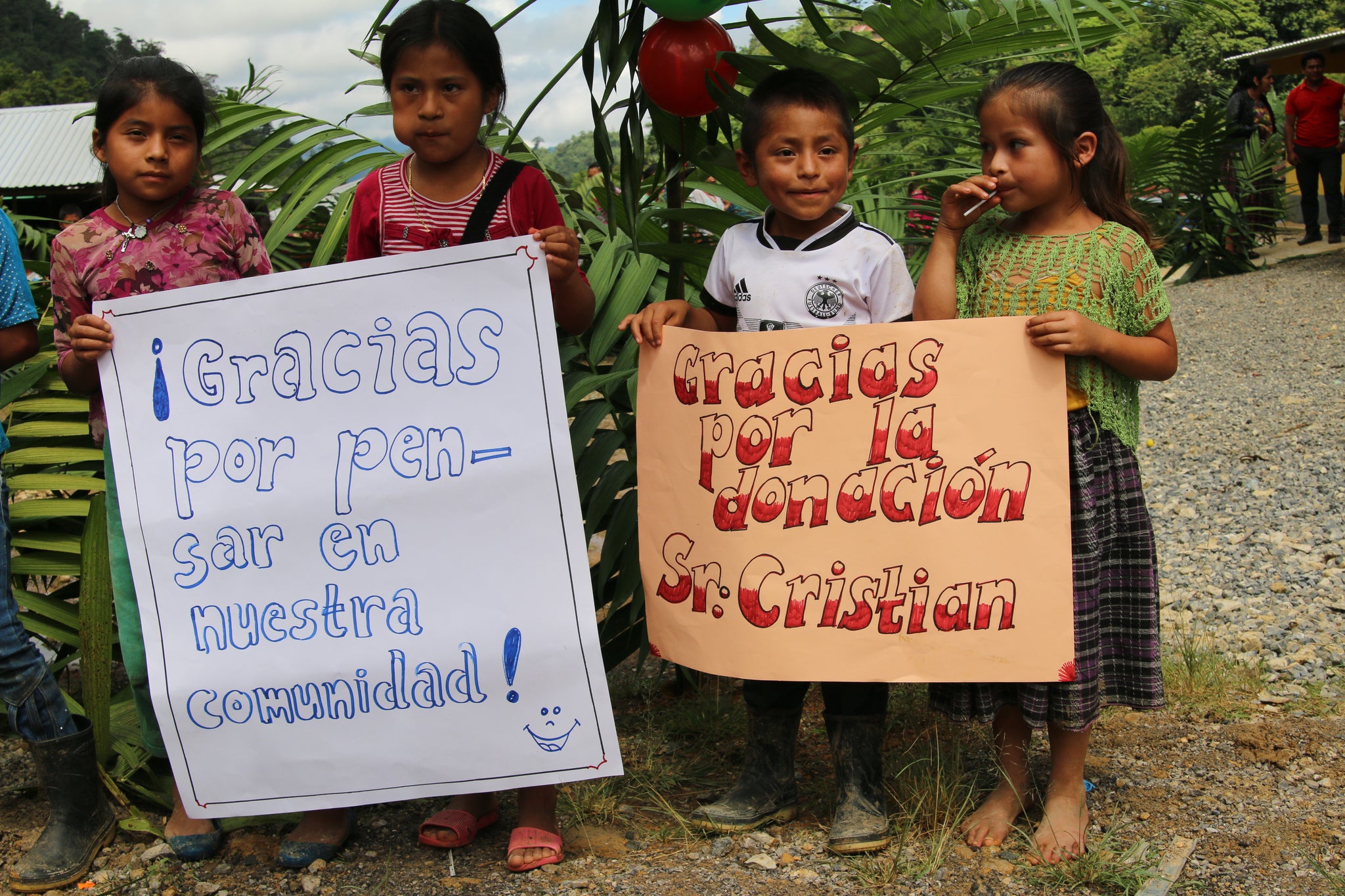 The left sign reads "Thanks for thinking about our community!" and the other "Thanks for your donation Mr. Christian"