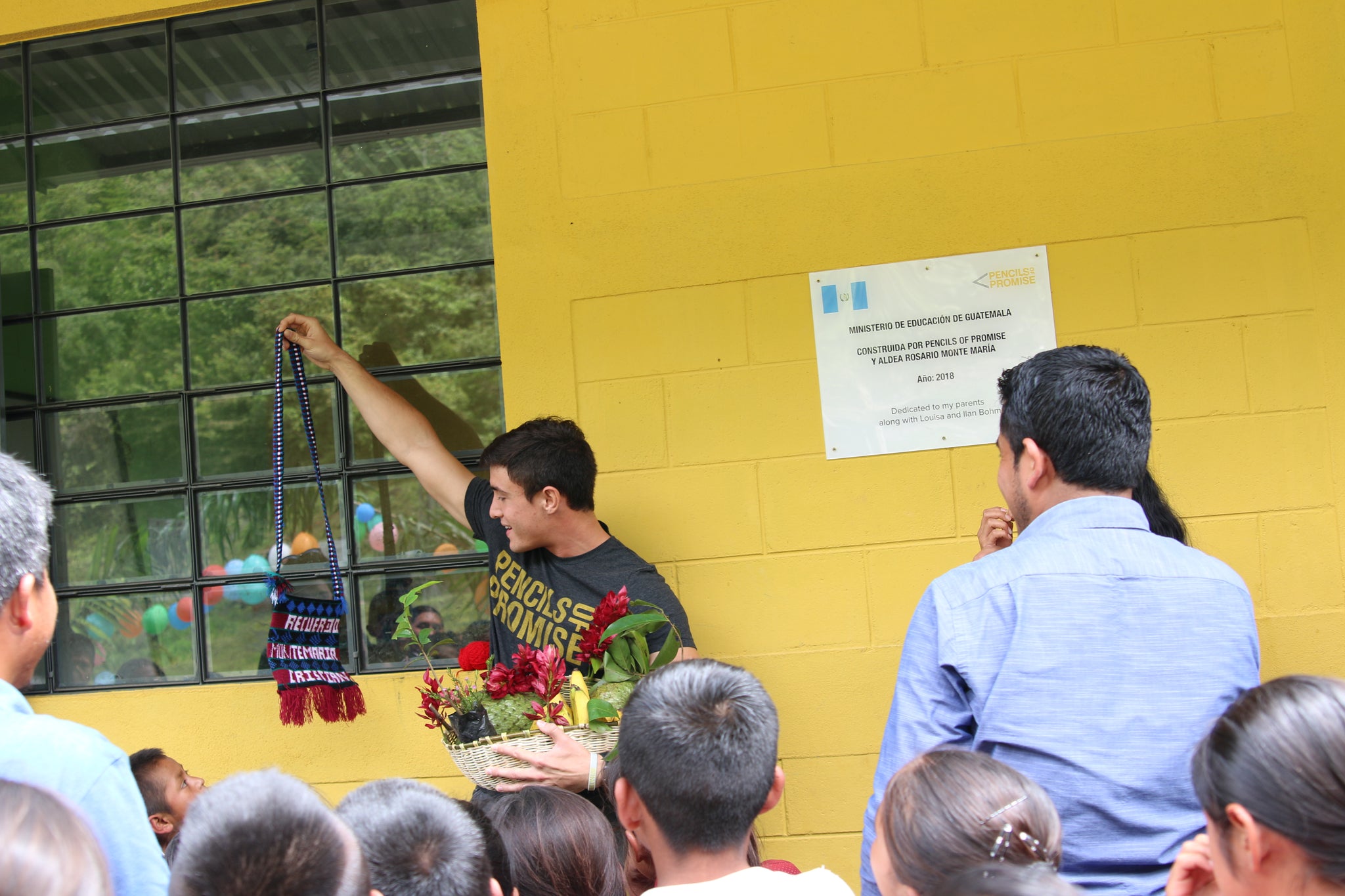 Christian being presented with a basket full of Guanabana