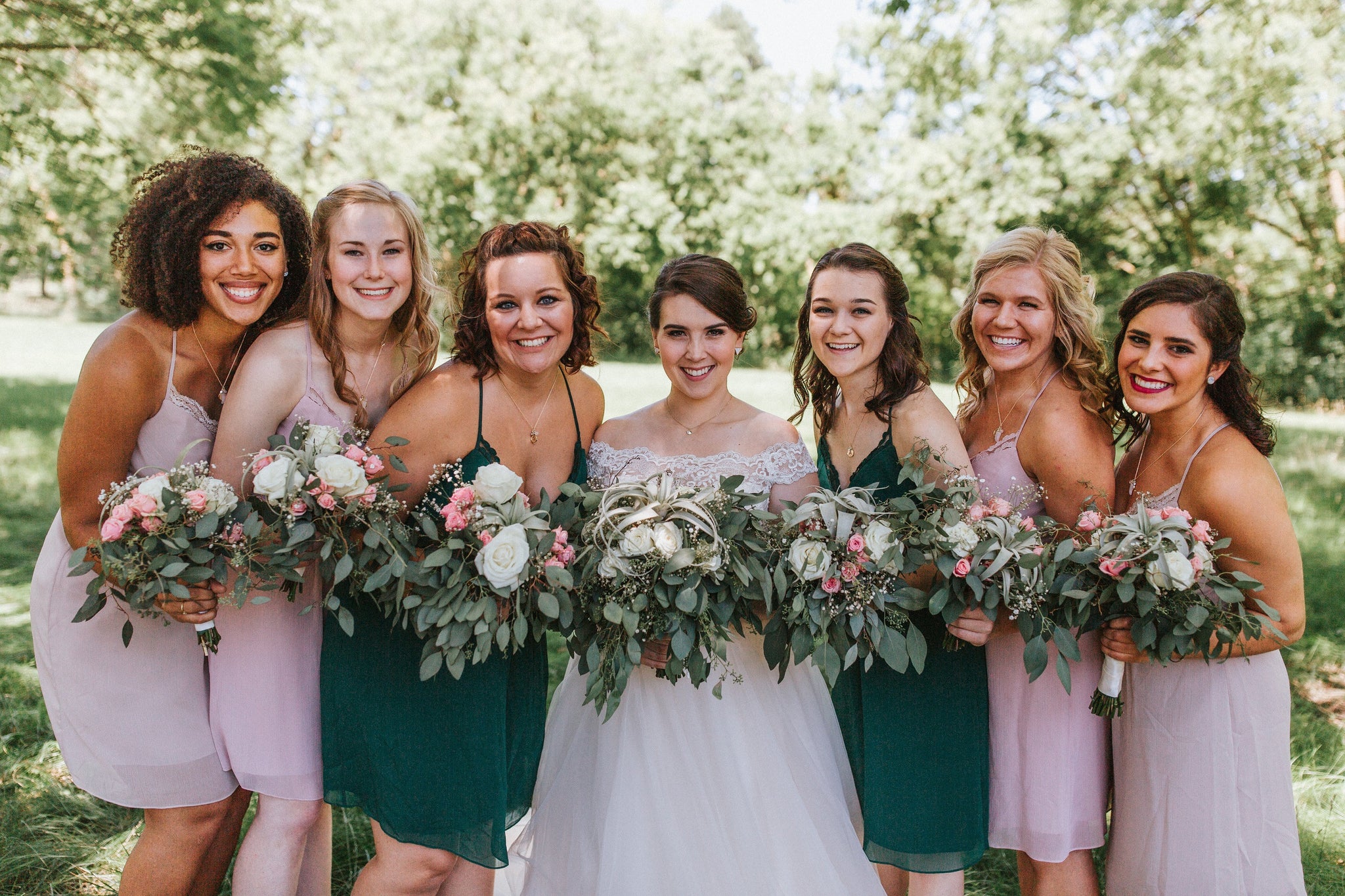 brides maids with wedding bouquets made with flowers and tillandsia air plants