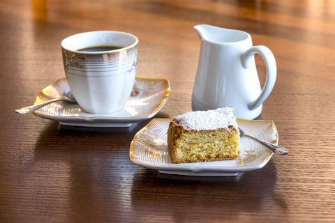 a cup of coffee and a slice of bread