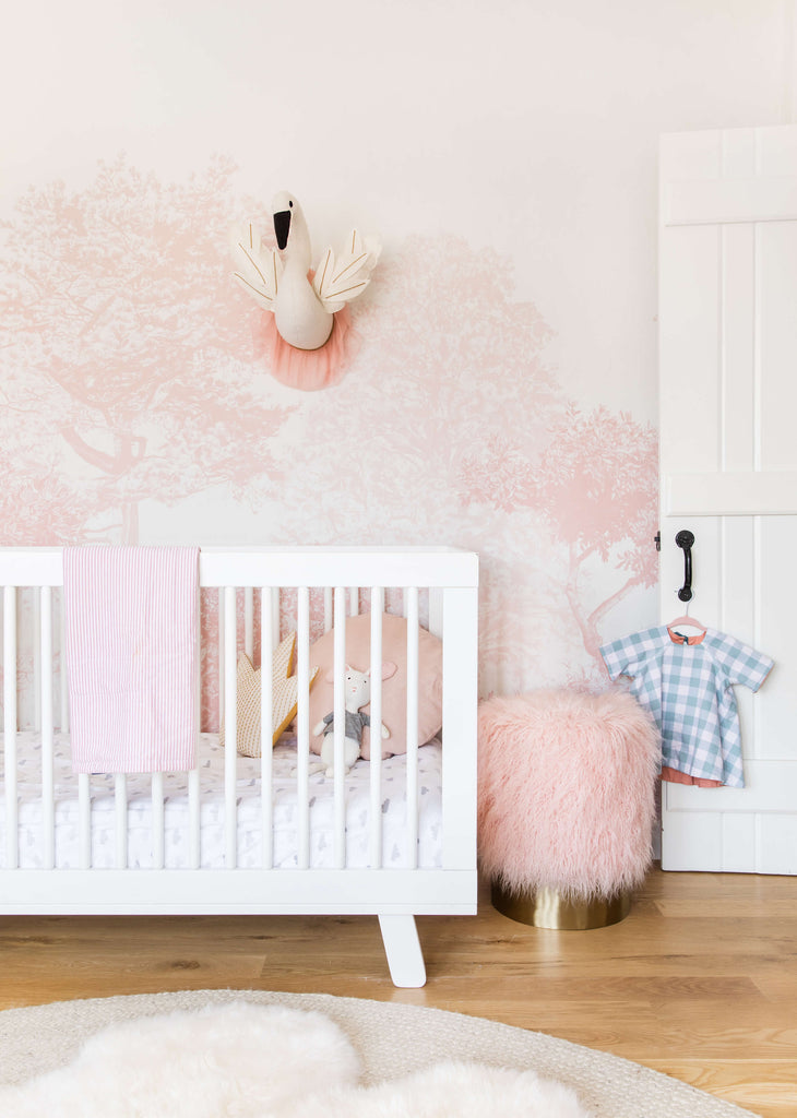 Dreamy pink nursery featuring Sian Zeng Hua Trees wallpaper in Pink / image by Emily Henderson