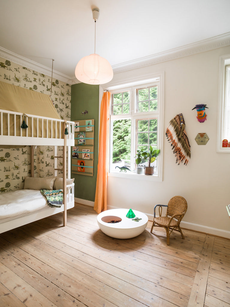 Dinosaurs roam in this kid's bedroom, with dinosaur wallpaper by Sian Zeng and bunk bed by Oliver Furniture / photo credit Lisbeth Kroll
