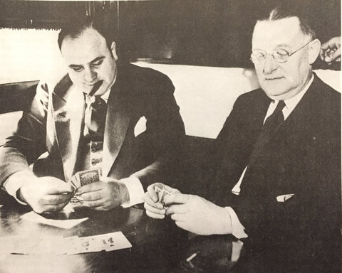 Al Capone en route to prison, playing cards with federal marshal.