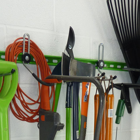 Garden tool rack for sheds and garages with a lawn mower