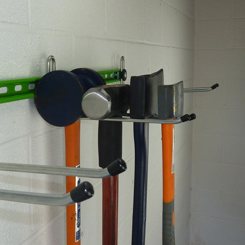 Garden tool rack for sheds and garages with axes and sledge hammers