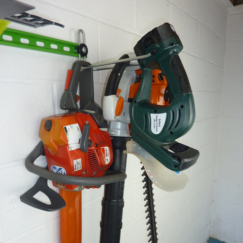 Garden tool rack for sheds and garages  with chain saw, leaf blower and hedge trimmer