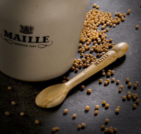 Maille mustard jar with mustard spoon and mustard seeds