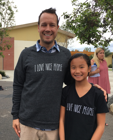 Kai with her sixth-grade teacher, John Tiersma.