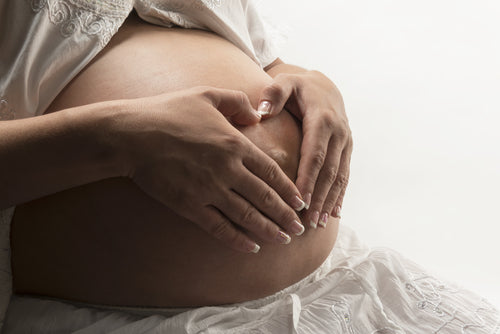 heart hands on pregnant woman