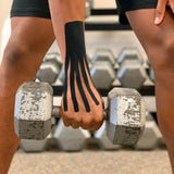 Man holding weight wearing kinesiology tape