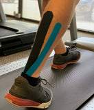 Man on treadmill wearing kinesiology tape
