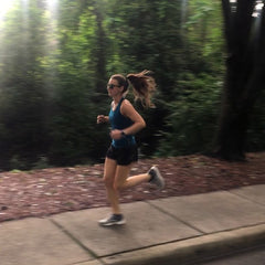 Woman running down the sidewalk