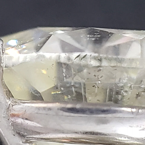 A diamond with laser drilled holes visible under magnification
