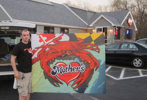 Outside of Mother's Grill with Citizen Pride mural