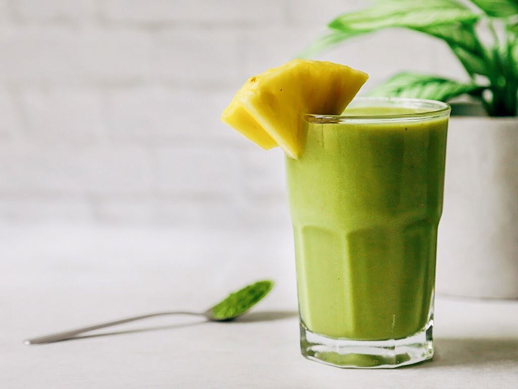 Tropical matcha smoothie glass with pineapple