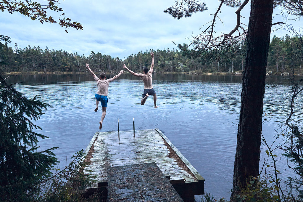 Rob and Chris jumping off a jetty into a lake