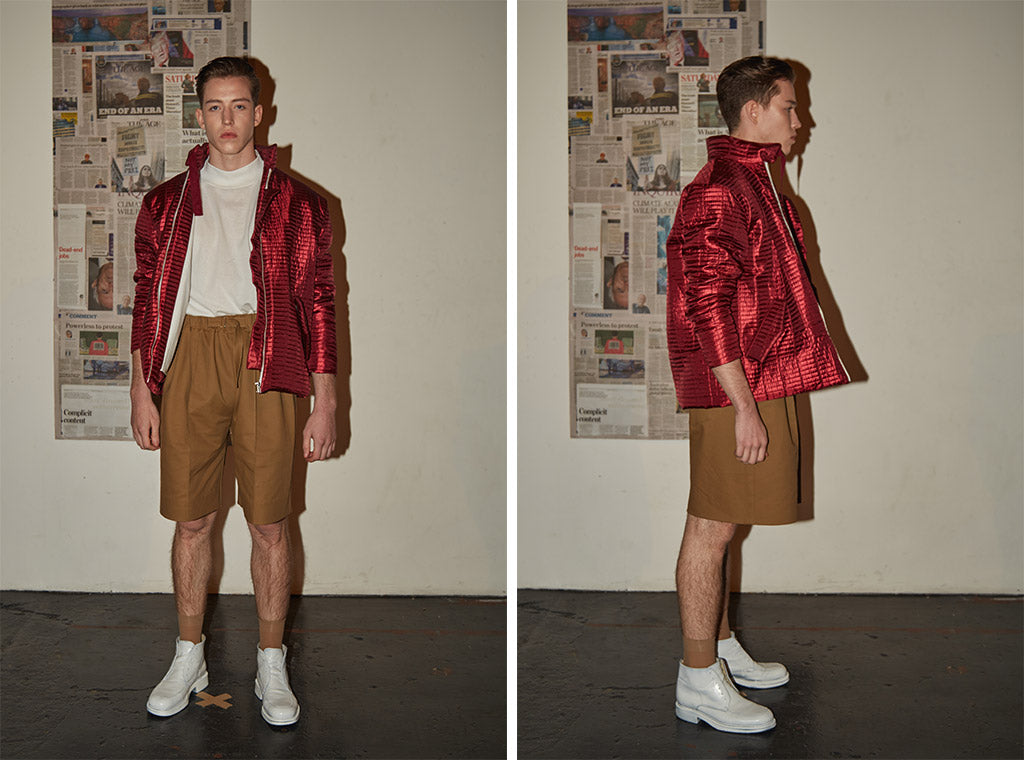 Caramel tailored knee-length shorts paired with white cotton turtle neck top and limited edition red metallic bomber jacket