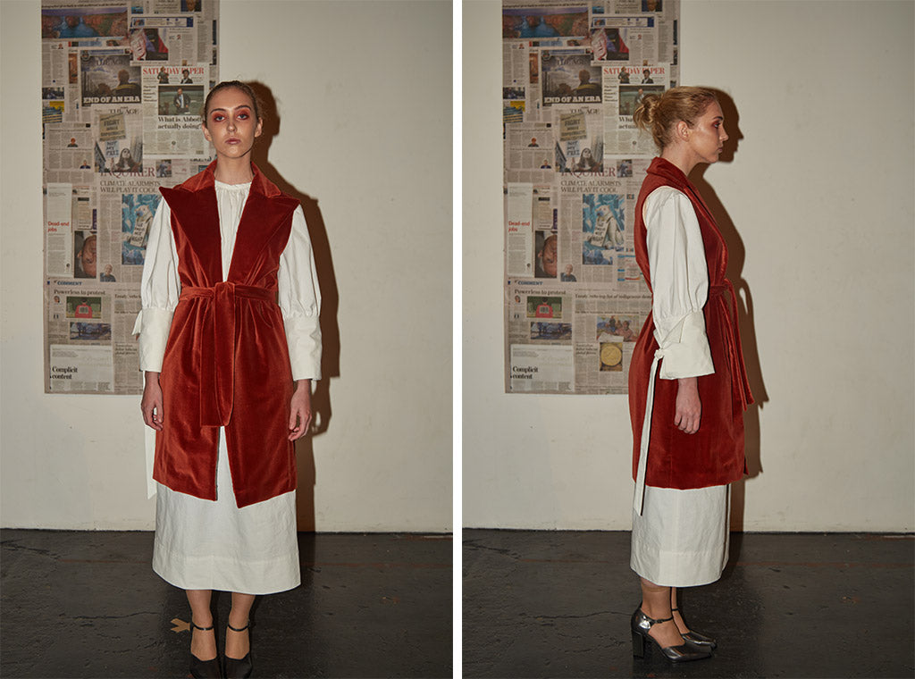 White cotton high-neck t-shirt dress with oversized sleeves paired with limited edition long red velvet waistcoat