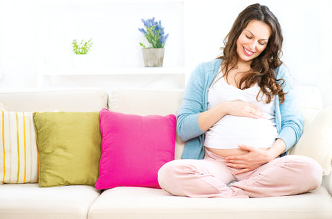 pregnant woman holding stomach