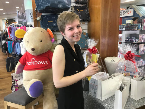 Molly selling raffle tickets and raising money for Rainbows Hospice at our Sip and Shop evening