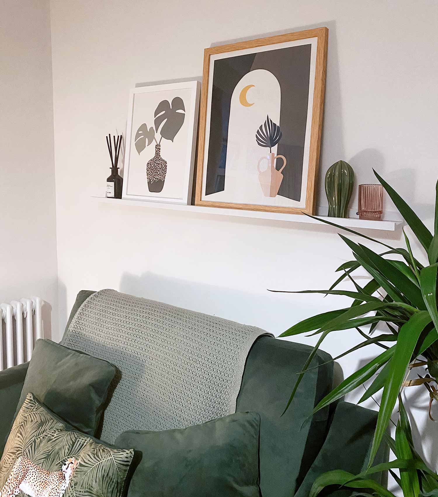 Green Lili Framed Botanical Prints on Picture Shelf above Sofa