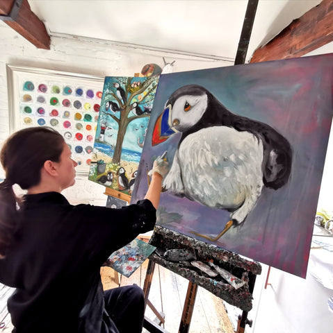 Dawn Painting one of her Puffins