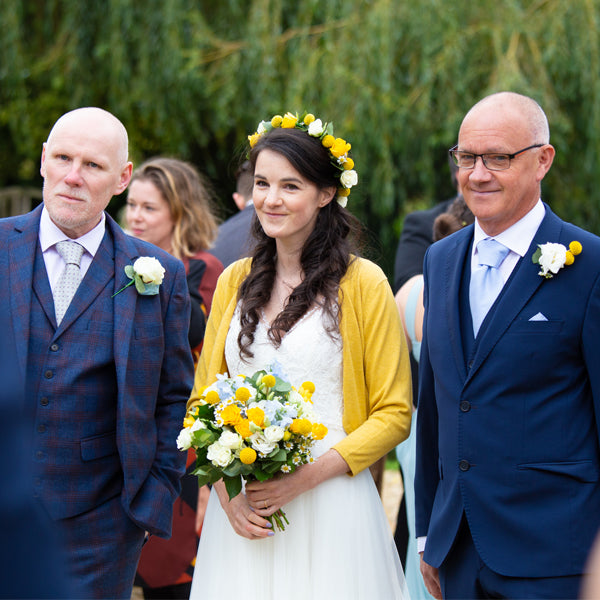 Joanne Hawker in her ivory wedding gown and a yellow cardigan