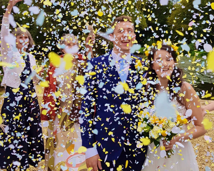 Confetti being thrown over the bride and groom