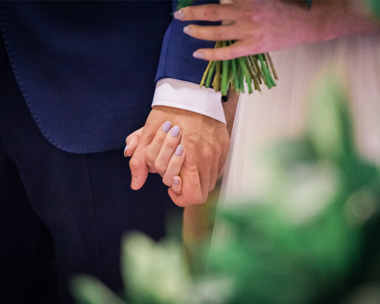 Holding hands after the exchange of the rings