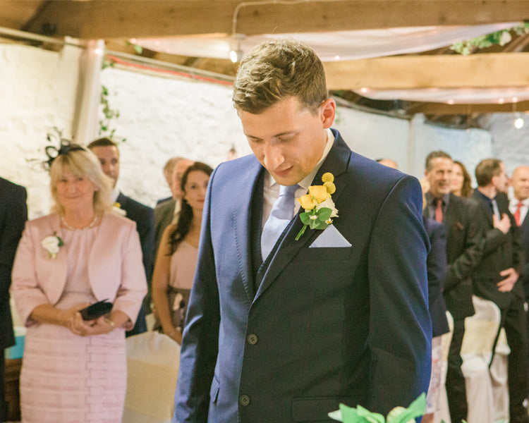Ross nervously waiting at the end of the aisle with his mum smiling at him