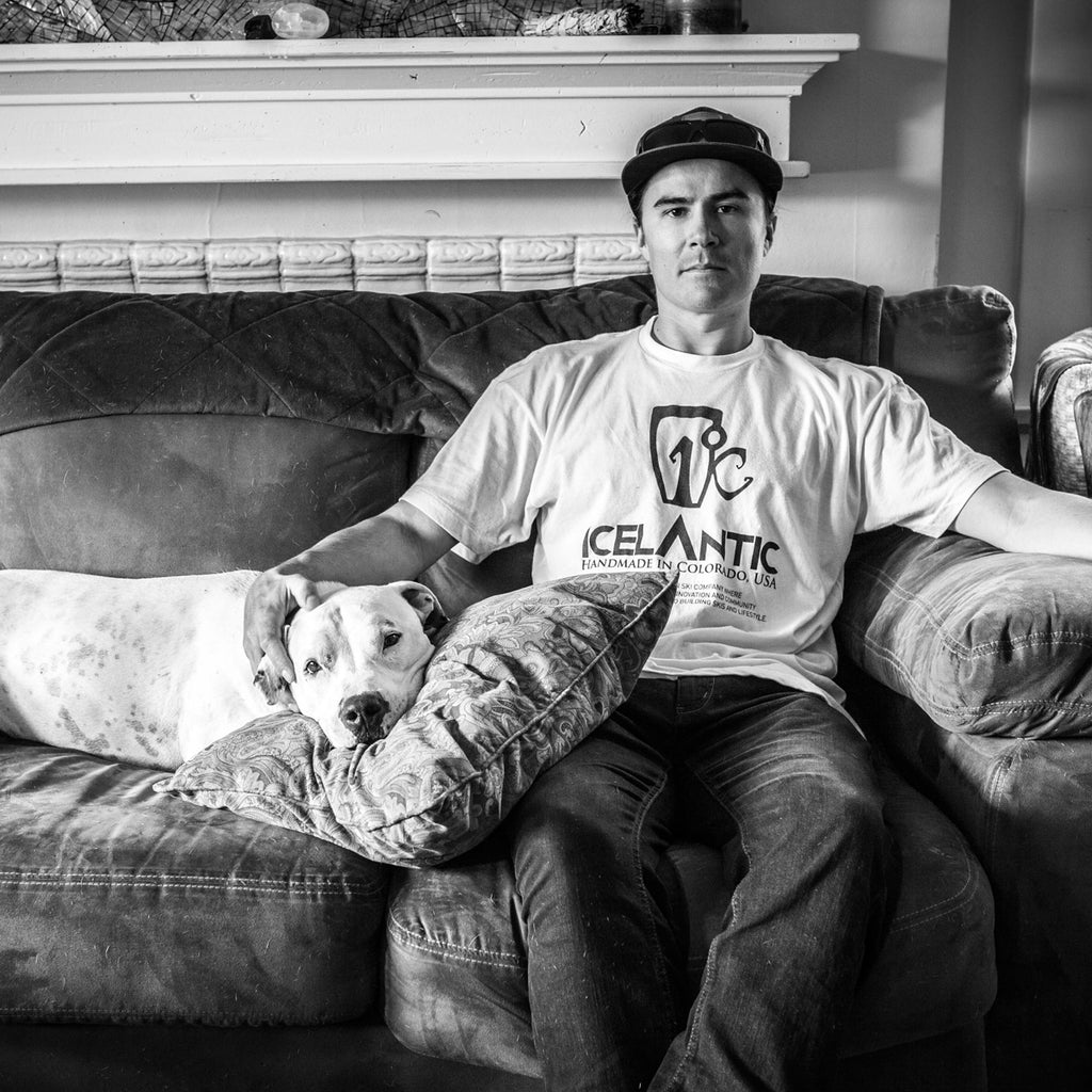 Julian Carr on his couch with his dog, Lexie.