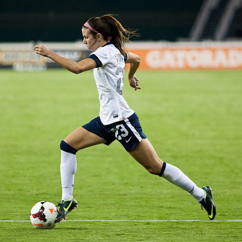 Erika moving soccer ball down the field.