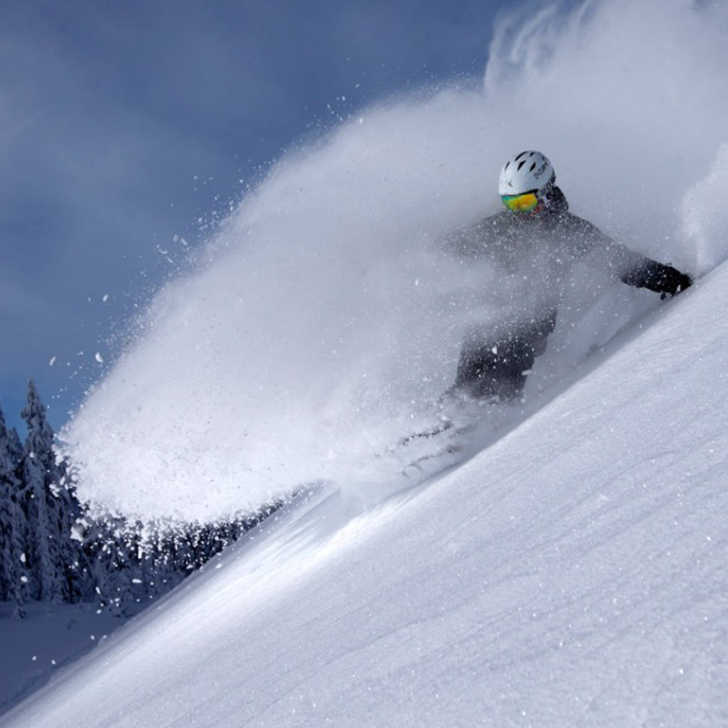 JD Platt snowboarding in deep powder.