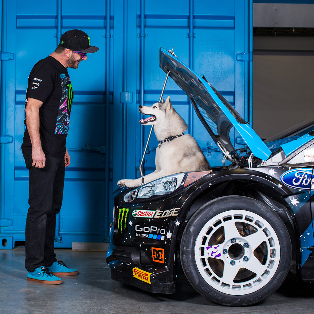 Ken Block and Bentley in the engine bay of Ken's Ford rally car.