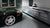 black sports car parked in front of an STKR Garage Parking Sensor LT in a very clean garage