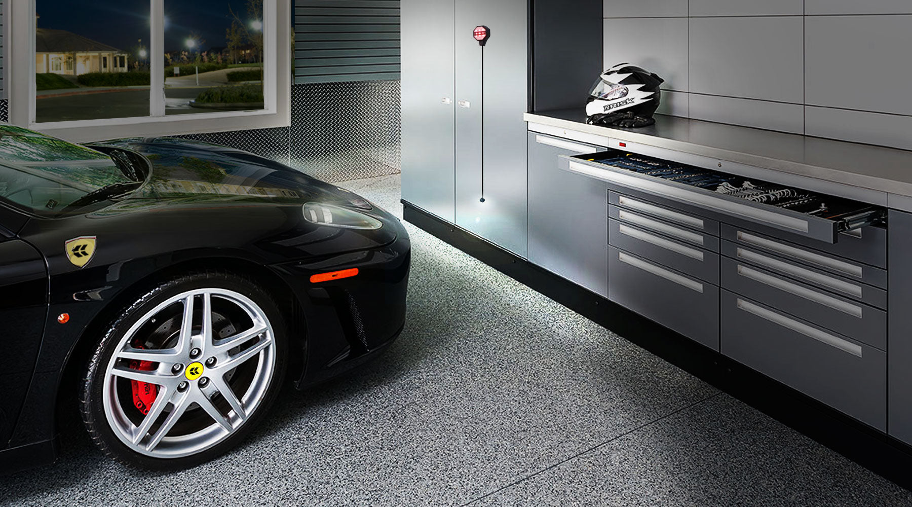 Garage Parking Sensor at night. Black sports car parking in front of grey garage cabinets.